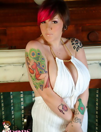 Dors Feline shows off her massive boobs in a white dress